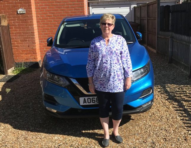 Picture showing former learner Susan Green with the car she bought after passing her test