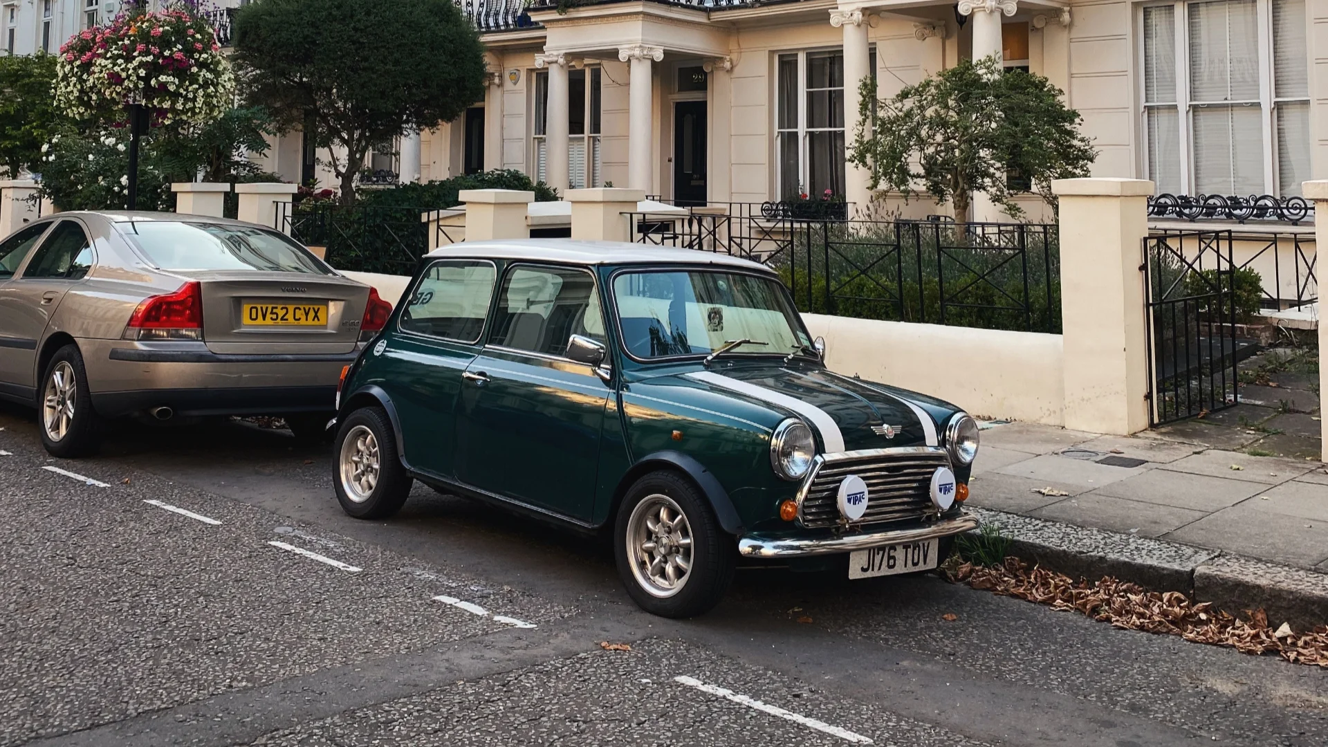 A car parked on a UK street after a successful parallel parking manoeuvre.