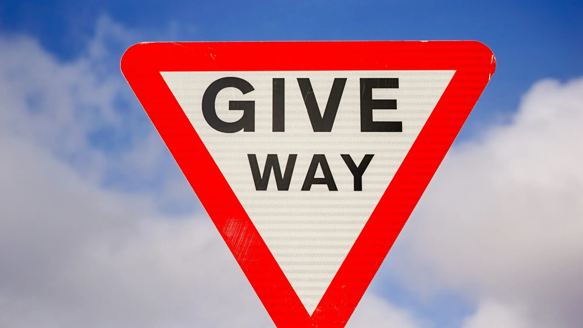 A triangular 'give way' sign, as seen on British roads at the approach to traffic junctions.